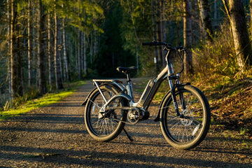 Step-through long-range electric bike parked on a forest trail path—ideal for UK countryside rides, daily commuting, and smooth all-terrain e-bike journeys from Glide & Gear.