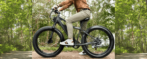 Person riding a green fat tyre electric bike on a forest trail, wearing casual attire with white sneakers, surrounded by lush green trees, highlighting the versatility of e-biking in nature.