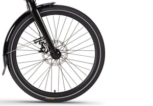 Detailed view of the Wisper 705 Step-Through e-bike's front wheel with fender and robust tyre design.