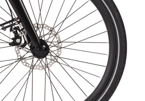 Front wheel of the Wisper 705 Step-Through Electric Bike featuring precision disc brakes and reflective tyre strip.