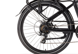 Close-up of Wisper 905 Touring e-bike’s rear wheel with Shimano gear system and durable tyres.