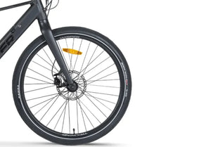 Detailed view of Kenda tyres and safety reflector on the front wheel of the Wisper Tailwind City electric bike at glide & gear